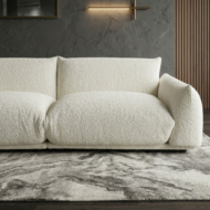 Modern cream white boucle sofa with deep seating and puffy armrests in minimalist luxury living room UAE