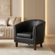 Black leather arm chair for living room with modern design and nailhead trim by kustomdeco